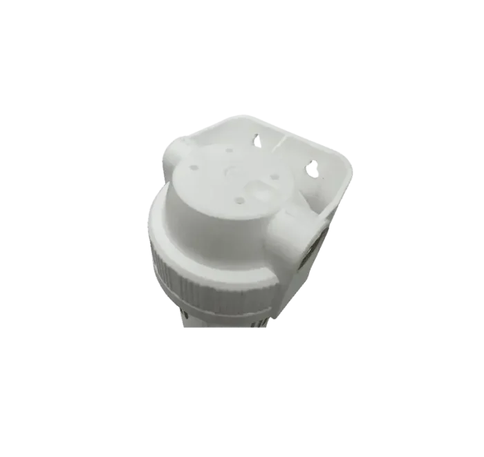 Close-up of a white plastic knob with a knurled edge, viewed from above, used to adjust a control.
