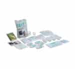 A kit and assorted wound-care supplies (bandages, gauze, tapes, antiseptics) laid out for first-aid use