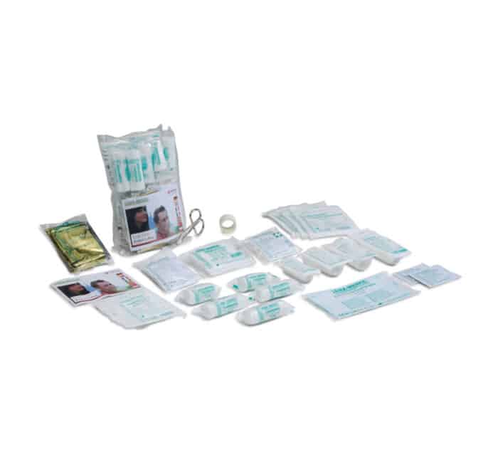 A kit and assorted wound-care supplies (bandages, gauze, tapes, antiseptics) laid out for first-aid use